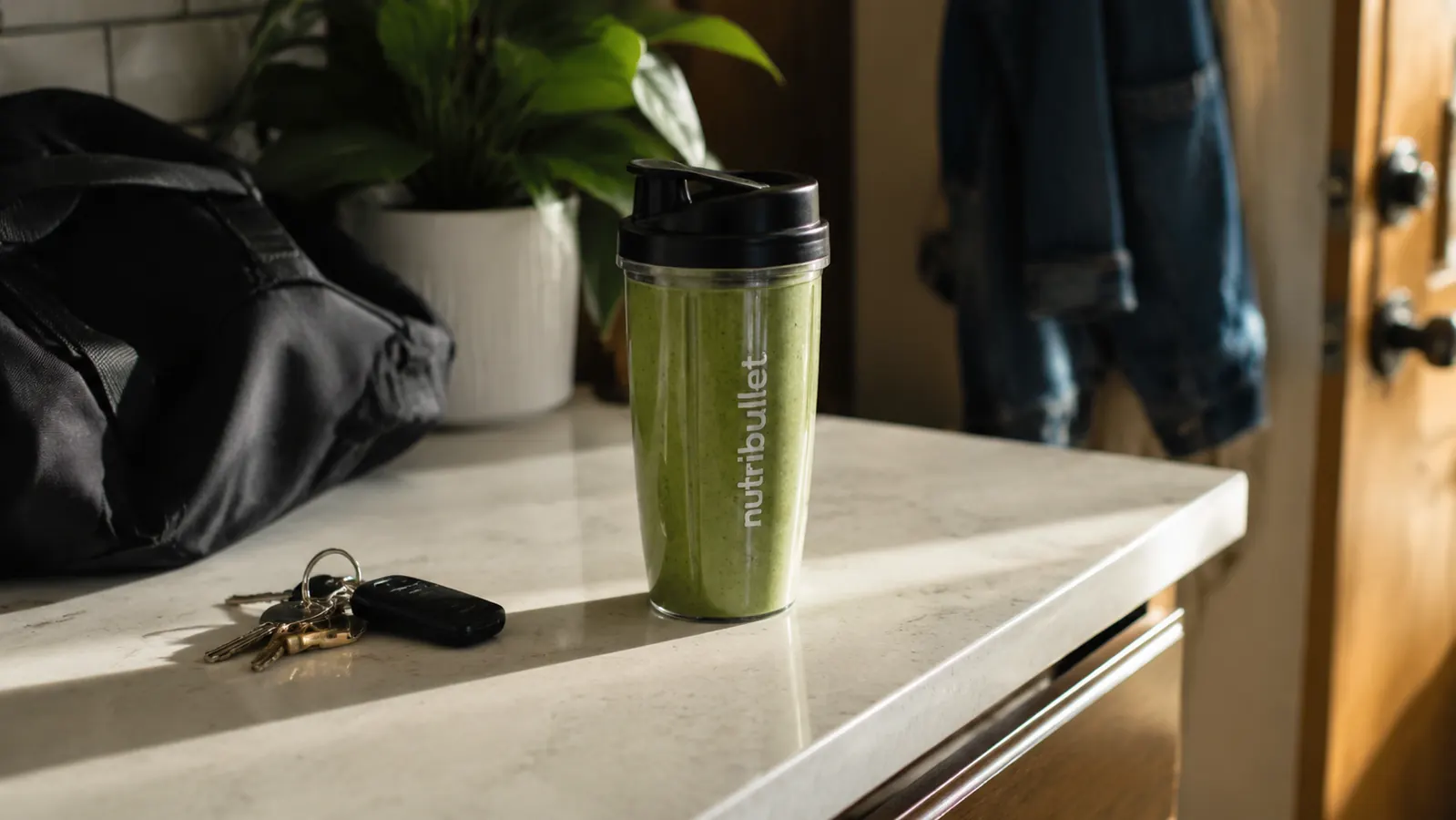 Completed smoothie in a NutriBullet travel cup with a lid on, ready to carry out the door